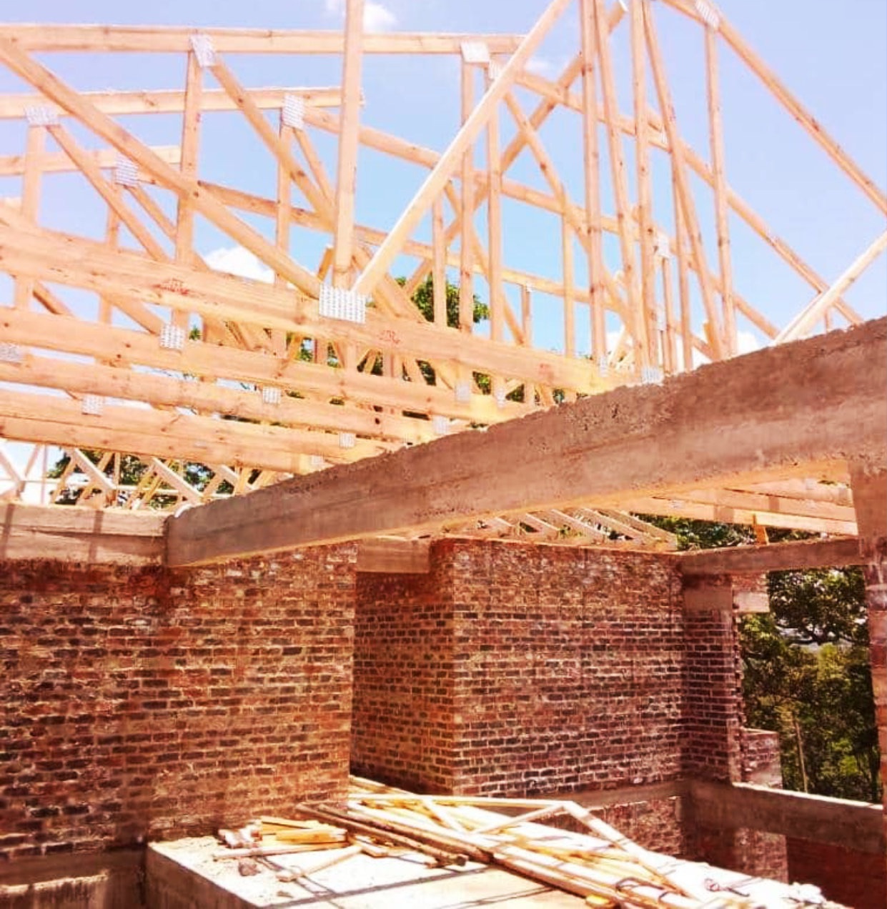 Prefabricated roof trusses being installed on a brick build